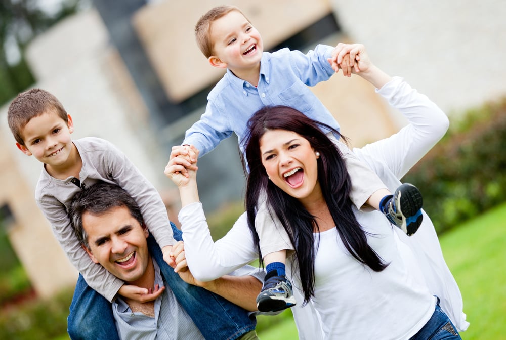 Happy family having fun running outdoors and smiling